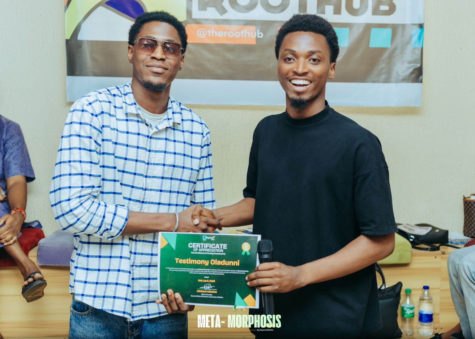 A speaker receives a certificate of appreciation with a handshake