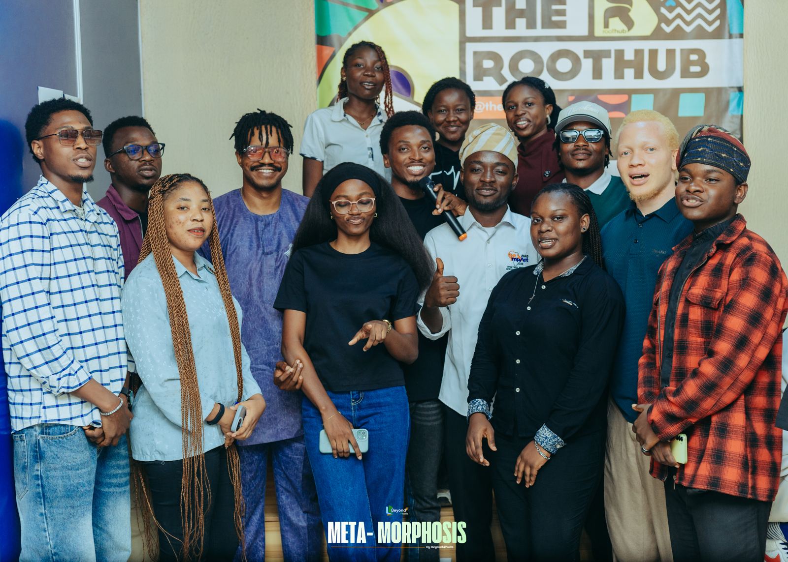 Metamorphosis attendees and speakers gathered for a group photo, smiling at the camera